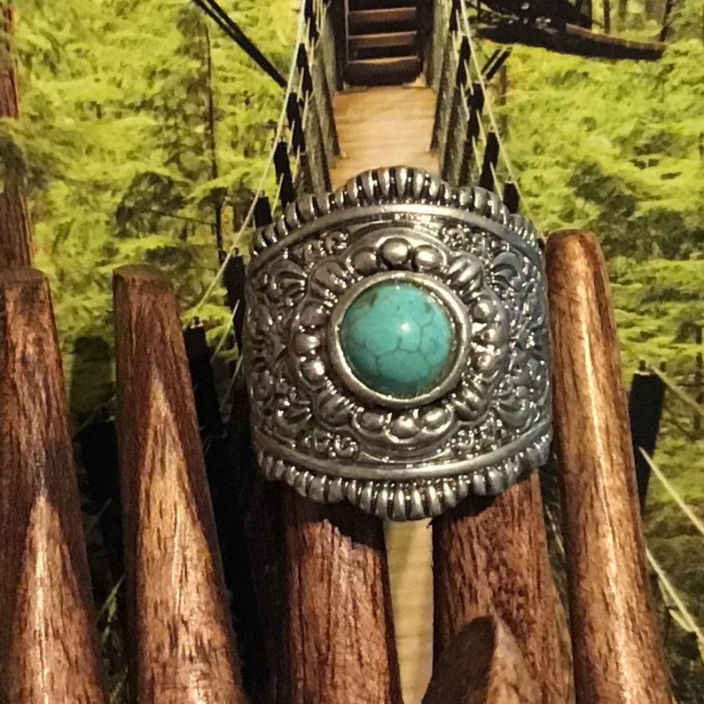 Women’s silver tone metal ring with Turquoise look stone and scroll work on band